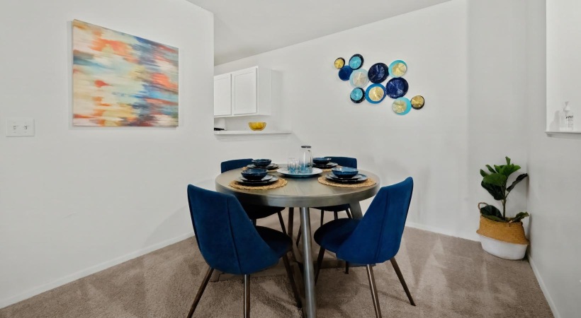 a dining room table with blue chairs