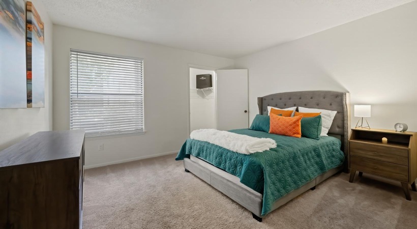 a bedroom with a bed and a desk