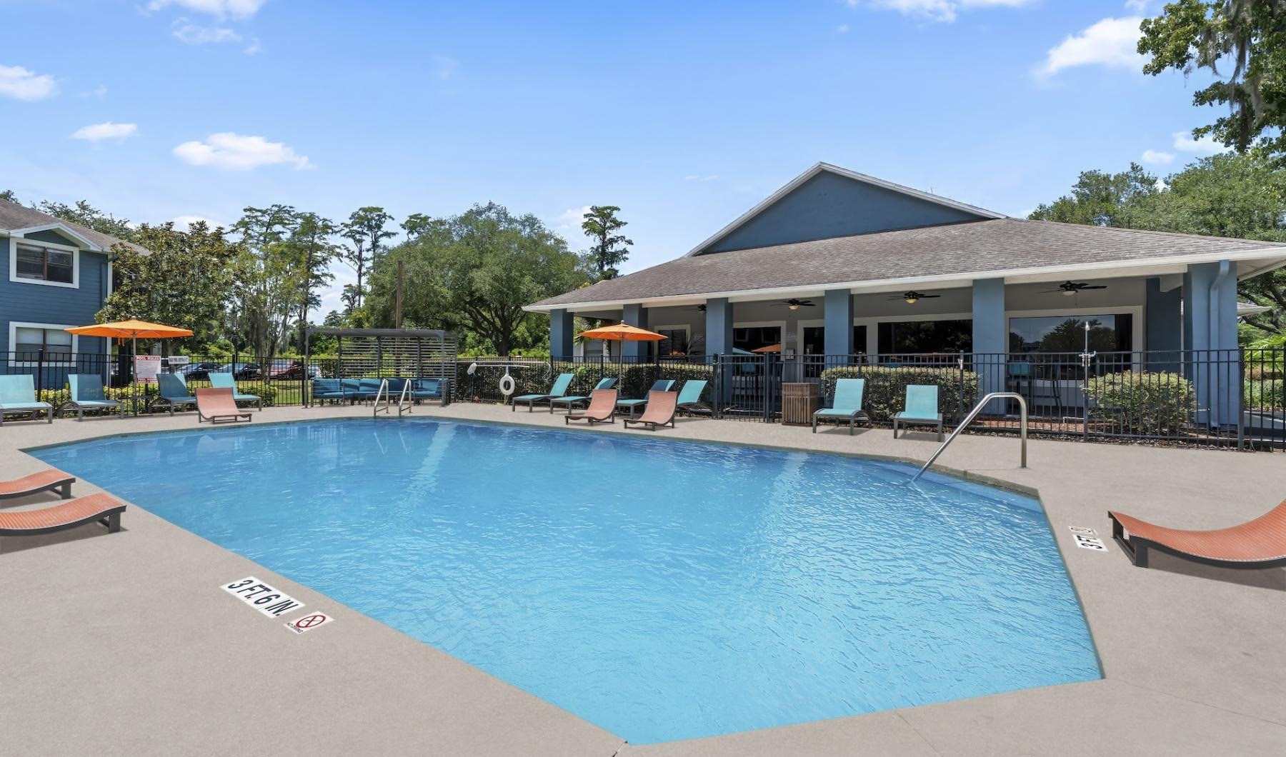 Resort-style swimming pool with lounge seating