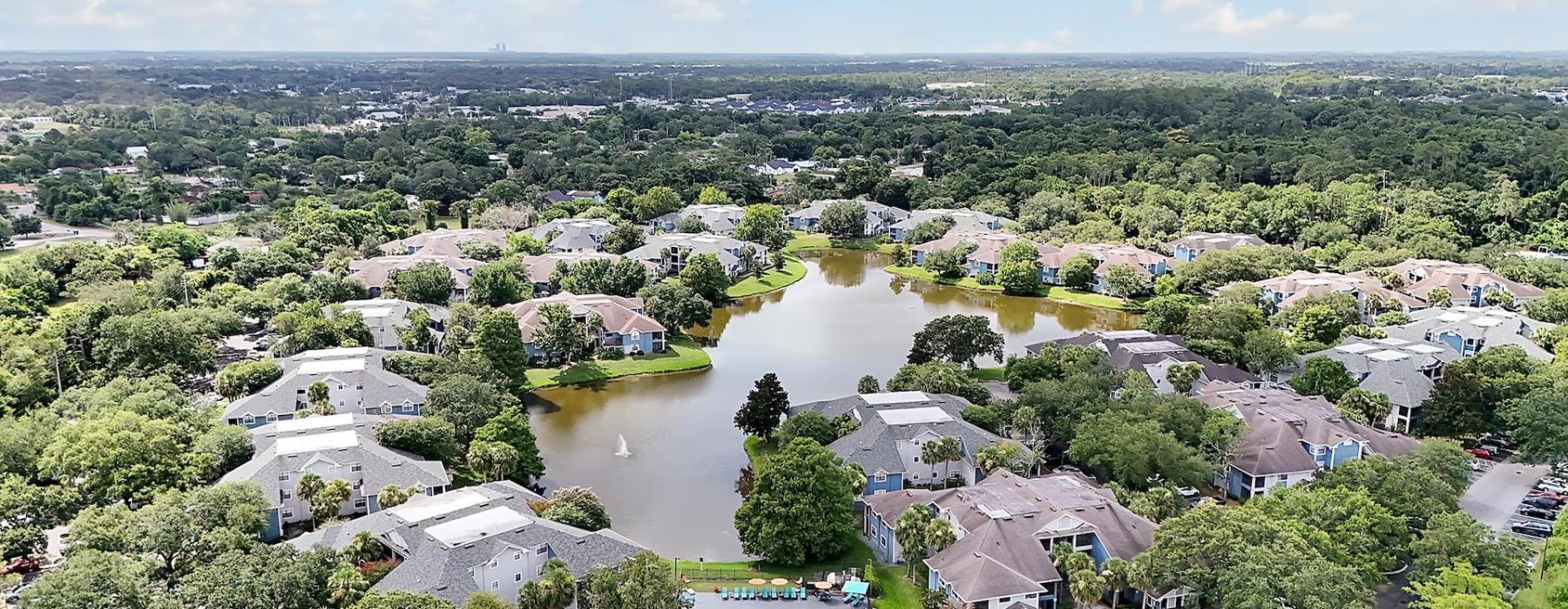 an aerial view of an apartment and a body of water